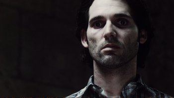 Movie still from “Munich” (2005), directed by Steven Spielberg – A person wearing a plaid shirt; Close Up shot, Low angle