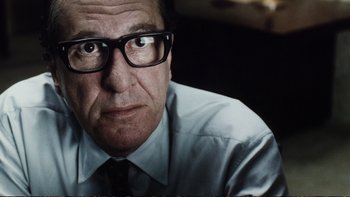 Movie still from “Munich” (2005), directed by Steven Spielberg – A person wearing a shirt and tie; Close Up shot, Low angle