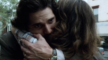 Movie still from “Munich” (2005), directed by Steven Spielberg – A man and a woman hugging each other; Close Up shot, Over the shoulder angle