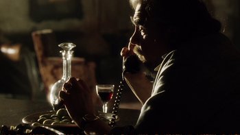 Movie still from “Munich” (2005), directed by Steven Spielberg – A woman sitting at a table talking on the phone; Close Up shot, Low angle