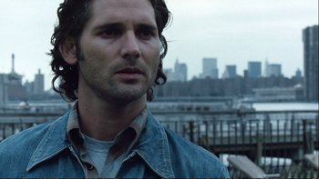 Movie still from “Munich” (2005), directed by Steven Spielberg – A person wearing a jean jacket; Close Up shot, Over the shoulder angle