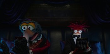 Movie still from “Muppets Haunted Mansion” (2021), directed by Kirk R. Thatcher – A couple of stuffed animals sitting next to each other; Medium shot, High angle