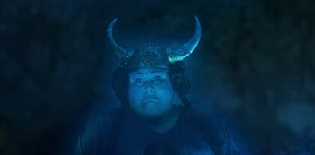 Movie still from “Muppets Haunted Mansion” (2021), directed by Kirk R. Thatcher – A man wearing a horned helmet in the dark; Close Up shot, High angle