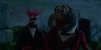 Movie still from “Muppets Haunted Mansion” (2021), directed by Kirk R. Thatcher – A couple of stuffed animals that are next to each other; Medium shot, High angle