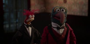 Movie still from “Muppets Haunted Mansion” (2021), directed by Kirk R. Thatcher – A couple of muppets are standing next to each other; Medium shot, Low angle