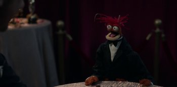 Movie still from “Muppets Haunted Mansion” (2021), directed by Kirk R. Thatcher – A stuffed animal wearing a suit; Extreme Close Up shot, High angle