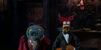 Movie still from “Muppets Haunted Mansion” (2021), directed by Kirk R. Thatcher – A couple of stuffed animals that are next to each other; Medium shot, High angle