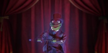 Movie still from “Muppets Haunted Mansion” (2021), directed by Kirk R. Thatcher – A frog in a suit and top hat holding a cane; Medium shot, Low angle