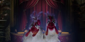 Movie still from “Muppets Haunted Mansion” (2021), directed by Kirk R. Thatcher – A couple of stuffed chickens sitting next to each other on a stage; Medium shot, High angle