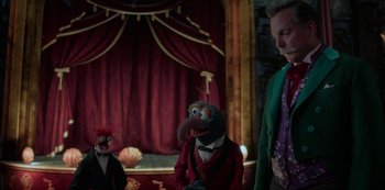 Movie still from “Muppets Haunted Mansion” (2021), directed by Kirk R. Thatcher – A couple of people that are standing up in a room; Medium shot, Over the shoulder angle