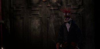 Movie still from “Muppets Haunted Mansion” (2021), directed by Kirk R. Thatcher – A stuffed animal wearing a suit and tie; Medium shot, High angle