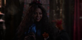 Movie still from “Muppets Haunted Mansion” (2021), directed by Kirk R. Thatcher – A woman in a blue dress and a man in a black suit; Close Up shot, Over the shoulder angle