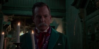 Movie still from “Muppets Haunted Mansion” (2021), directed by Kirk R. Thatcher – A person wearing a suit and tie; Close Up shot, Over the shoulder angle