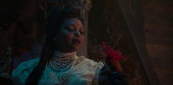 Movie still from “Muppets Haunted Mansion” (2021), directed by Kirk R. Thatcher – A woman in a white dress holding a pink flower; Close Up shot, Over the shoulder angle