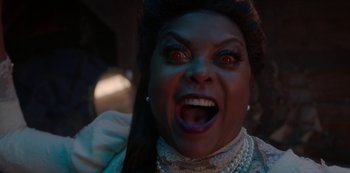 Movie still from “Muppets Haunted Mansion” (2021), directed by Kirk R. Thatcher – A woman with red eyes and a large mouth; Close Up shot, High angle