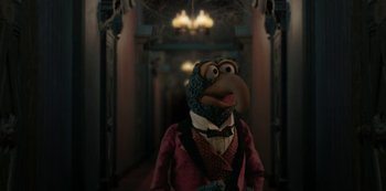 Movie still from “Muppets Haunted Mansion” (2021), directed by Kirk R. Thatcher – A person wearing a costume in a room; Medium shot, Low angle