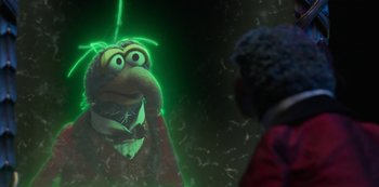 Movie still from “Muppets Haunted Mansion” (2021), directed by Kirk R. Thatcher – A person is looking at a puppet in the dark; Close Up shot, Over the shoulder angle