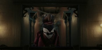 Movie still from “Muppets Haunted Mansion” (2021), directed by Kirk R. Thatcher – A puppet is standing in front of a mirror; Medium shot, Low angle