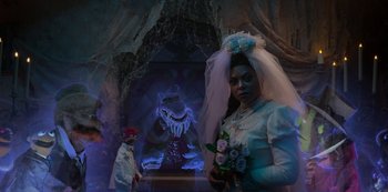 Movie still from “Muppets Haunted Mansion” (2021), directed by Kirk R. Thatcher – A woman in a wedding dress holding a bouquet of flowers; Wide shot, Over the shoulder angle