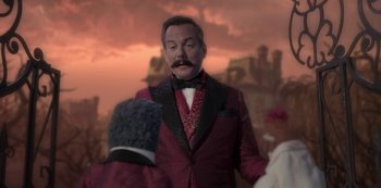 Movie still from “Muppets Haunted Mansion” (2021), directed by Kirk R. Thatcher – A man in a red suit and a black hat; Medium shot, Over the shoulder angle