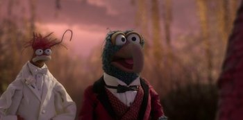 Movie still from “Muppets Haunted Mansion” (2021), directed by Kirk R. Thatcher – A muppet wearing a suit and tie; Close Up shot, Over the shoulder angle