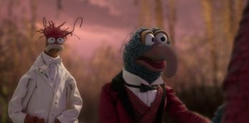 Movie still from “Muppets Haunted Mansion” (2021), directed by Kirk R. Thatcher – A muppet wearing a red jacket and a white shirt; Close Up shot, Over the shoulder angle