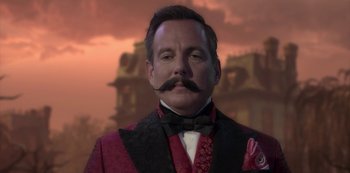 Movie still from “Muppets Haunted Mansion” (2021), directed by Kirk R. Thatcher – A person wearing a suit and tie; Close Up shot, Over the shoulder angle