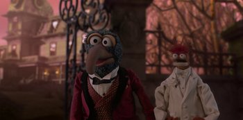Movie still from “Muppets Haunted Mansion” (2021), directed by Kirk R. Thatcher – A couple of muppets are standing next to each other; Medium shot, Low angle