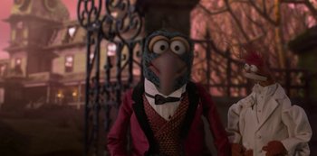 Movie still from “Muppets Haunted Mansion” (2021), directed by Kirk R. Thatcher – A person wearing a bird mask and a red jacket; Close Up shot, Low angle