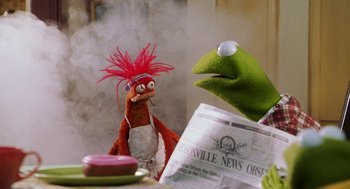 Movie still from “Muppets from Space” (1999), directed by Tim Hill – A couple of stuffed animals sitting next to each other on top of a table; Close Up shot, Over the shoulder angle