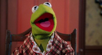 Movie still from “Muppets from Space” (1999), directed by Tim Hill – The face of a kermit the frog doll; Close Up shot, Over the shoulder angle