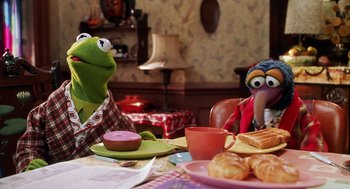 Movie still from “Muppets from Space” (1999), directed by Tim Hill – A couple of people sitting at a table with food on it; Medium shot, Over the shoulder angle