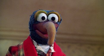Movie still from “Muppets from Space” (1999), directed by Tim Hill – A stuffed animal wearing a suit; Close Up shot, Over the shoulder angle