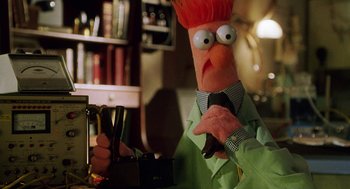 Movie still from “Muppets from Space” (1999), directed by Tim Hill – A character dressed in a suit and tie; Medium shot, Low angle