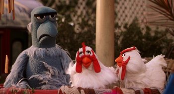 Movie still from “Muppets from Space” (1999), directed by Tim Hill – A group of three stuffed animals sitting next to each other; Close Up shot, High angle