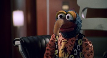 Movie still from “Muppets from Space” (1999), directed by Tim Hill – A person wearing a bird mask; Medium shot, Over the shoulder angle