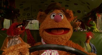 Movie still from “Muppets from Space” (1999), directed by Tim Hill – A stuffed animal driving a car; Close Up shot, High angle