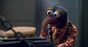 Movie still from “Muppets from Space” (1999), directed by Tim Hill – A person wearing a bird mask; Close Up shot, Over the shoulder angle
