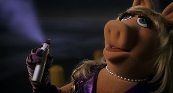Movie still from “Muppets from Space” (1999), directed by Tim Hill – A person's face with a makeup brush; Close Up shot, Low angle