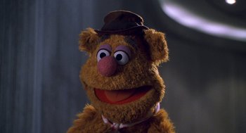 Movie still from “Muppets from Space” (1999), directed by Tim Hill – The face of a stuffed animal wearing a hat; Close Up shot, Over the shoulder angle