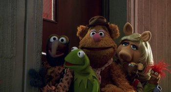 Movie still from “Muppets from Space” (1999), directed by Tim Hill – A group of stuffed animals sitting next to each other in a room; Close Up shot, High angle