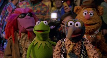 Movie still from “Muppets from Space” (1999), directed by Tim Hill – A group of people taking pictures of a group of puppets; Medium shot, Low angle