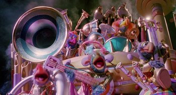 Movie still from “Muppets from Space” (1999), directed by Tim Hill – A bunch of stuffed animals that are sitting in a pile; Extreme Wide shot, High angle