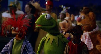 Movie still from “Muppets from Space” (1999), directed by Tim Hill – A group of people standing next to each other; Medium shot, Over the shoulder angle