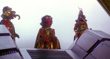 Movie still from “Muppets from Space” (1999), directed by Tim Hill – A couple of people that are dressed up; Medium shot, Low angle