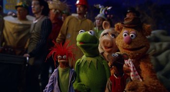 Movie still from “Muppets from Space” (1999), directed by Tim Hill – A group of people standing next to each other; Medium shot, High angle