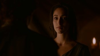 Movie still from “Game of Thrones” (2011), created by D.B. Weiss – A beautiful young woman in a dark room; Close Up shot, Over the shoulder angle