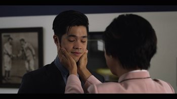 Movie still from “13 Reasons Why” (2017), created by Brian Yorkey – A woman touching the chin of a young man; Close Up shot, Over the shoulder angle