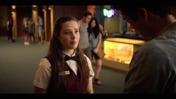 Movie still from “13 Reasons Why” (2017), created by Brian Yorkey – A woman in a red vest and a black bow tie; Medium shot, Over the shoulder angle