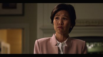 Movie still from “13 Reasons Why” (2017), created by Brian Yorkey – A woman in a pink jacket looking at the camera; Close Up shot, Over the shoulder angle